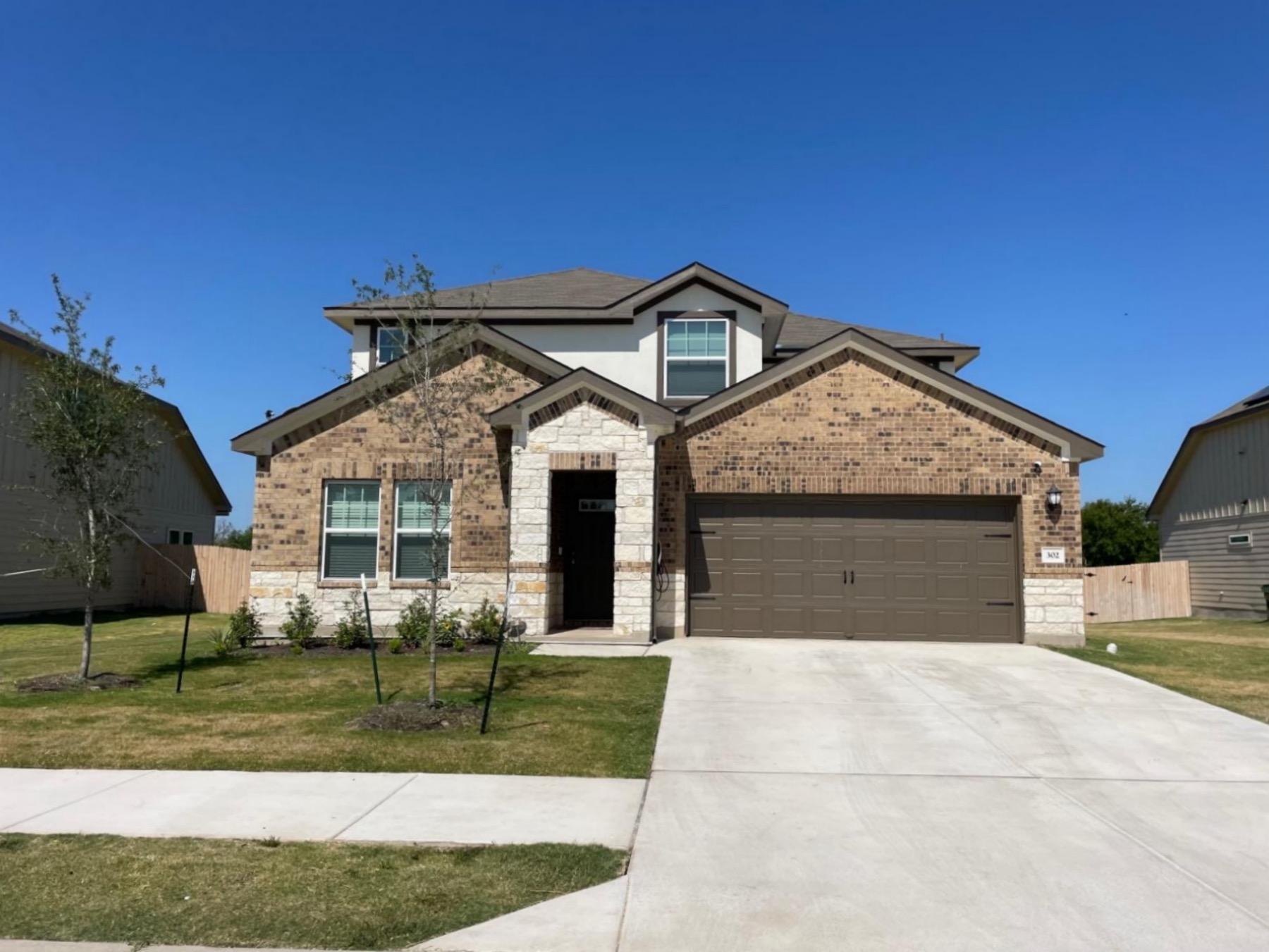 cross creek stone stucco brick home in hutto texas