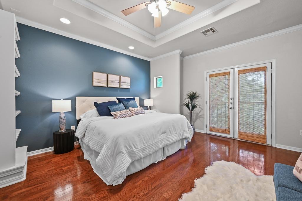 primary bedroom with Juliet balcony in Austin TX condo with professional listing photography