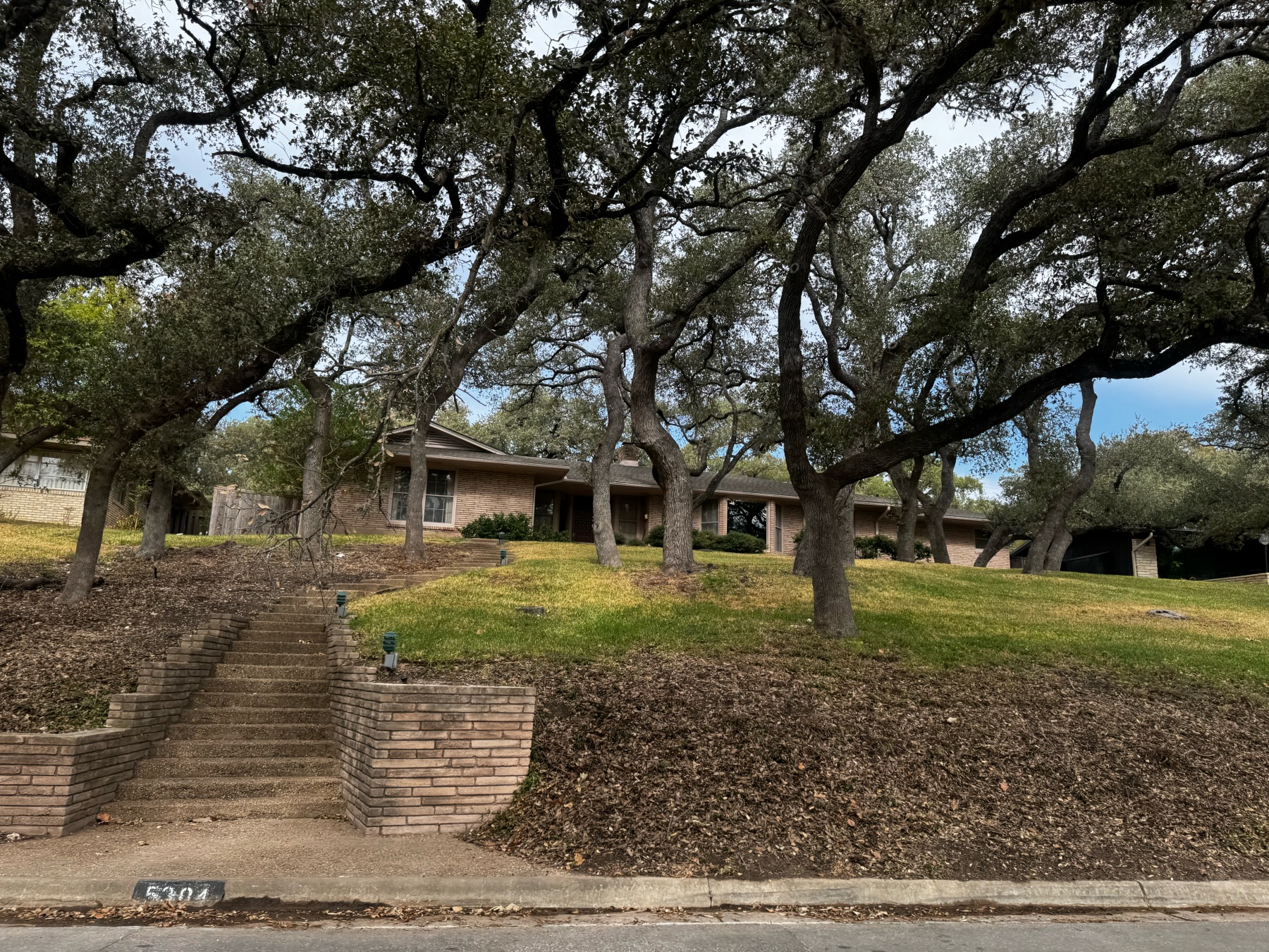 Highland Park West Balcones home above street wooded lot