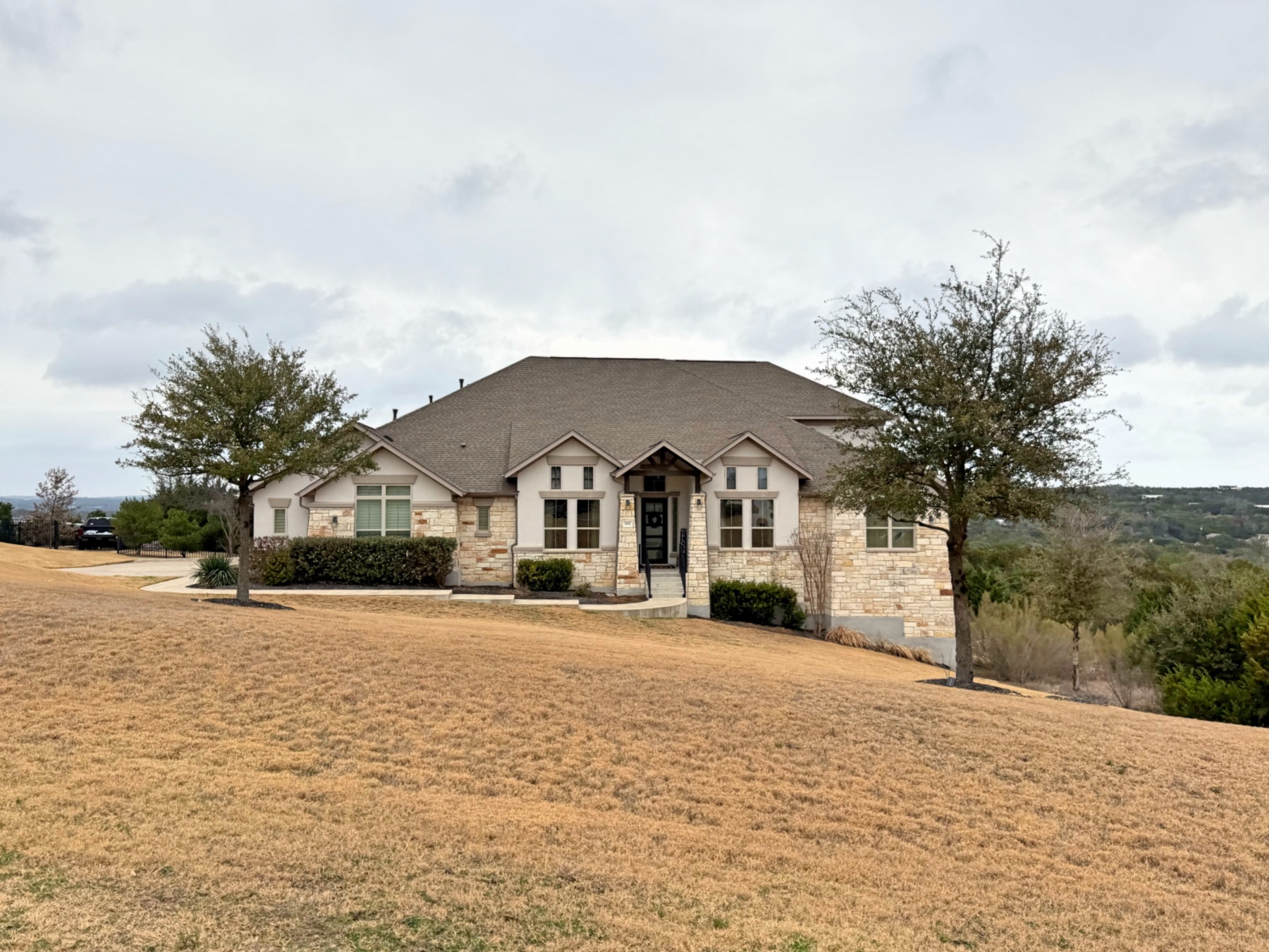 Saratoga Hills Austin TX 78737 two-story luxury home with stone and stucco exterior