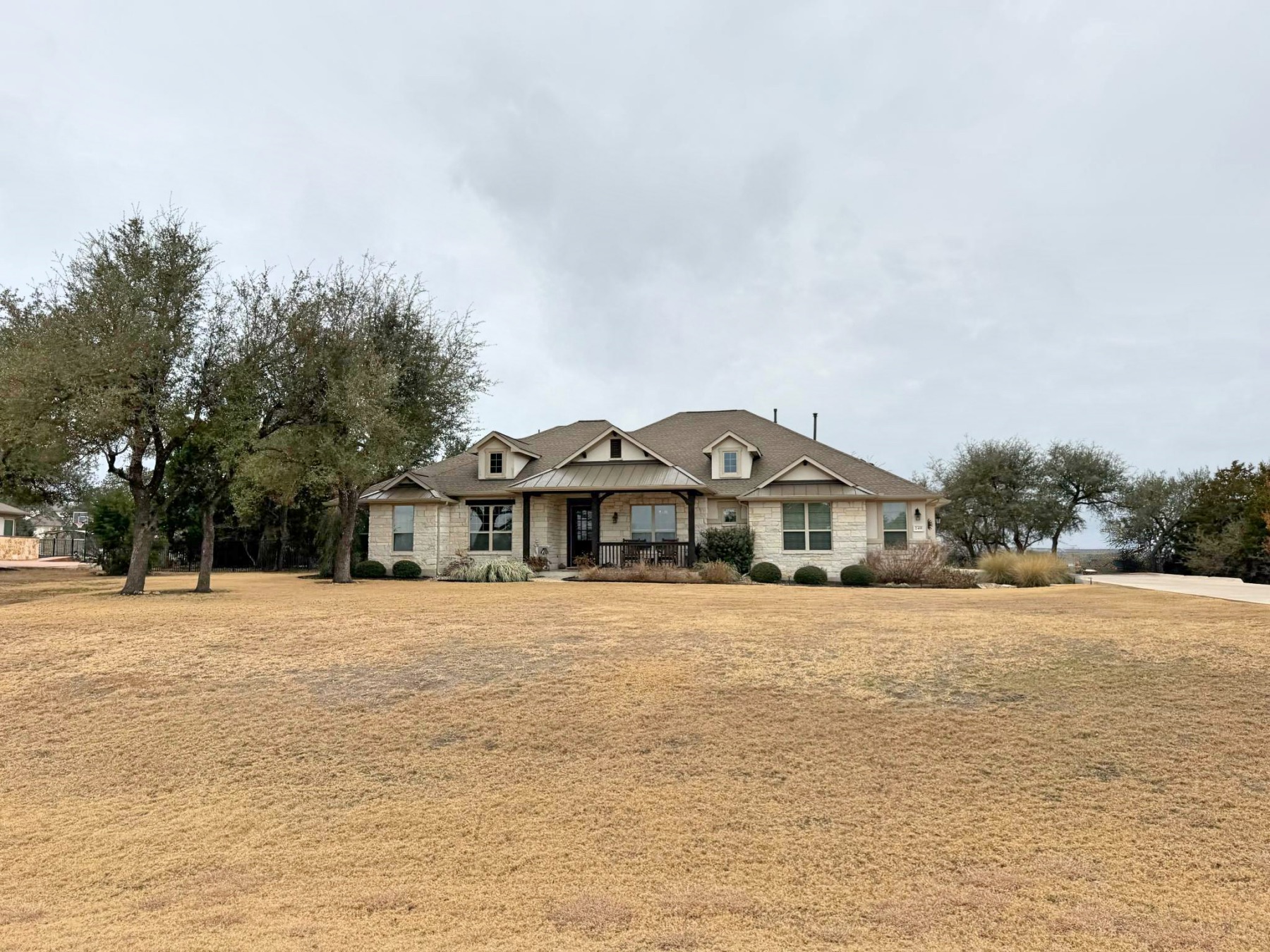 Saratoga Hills Austin TX 78737 luxury home with detached garage and mature oak trees