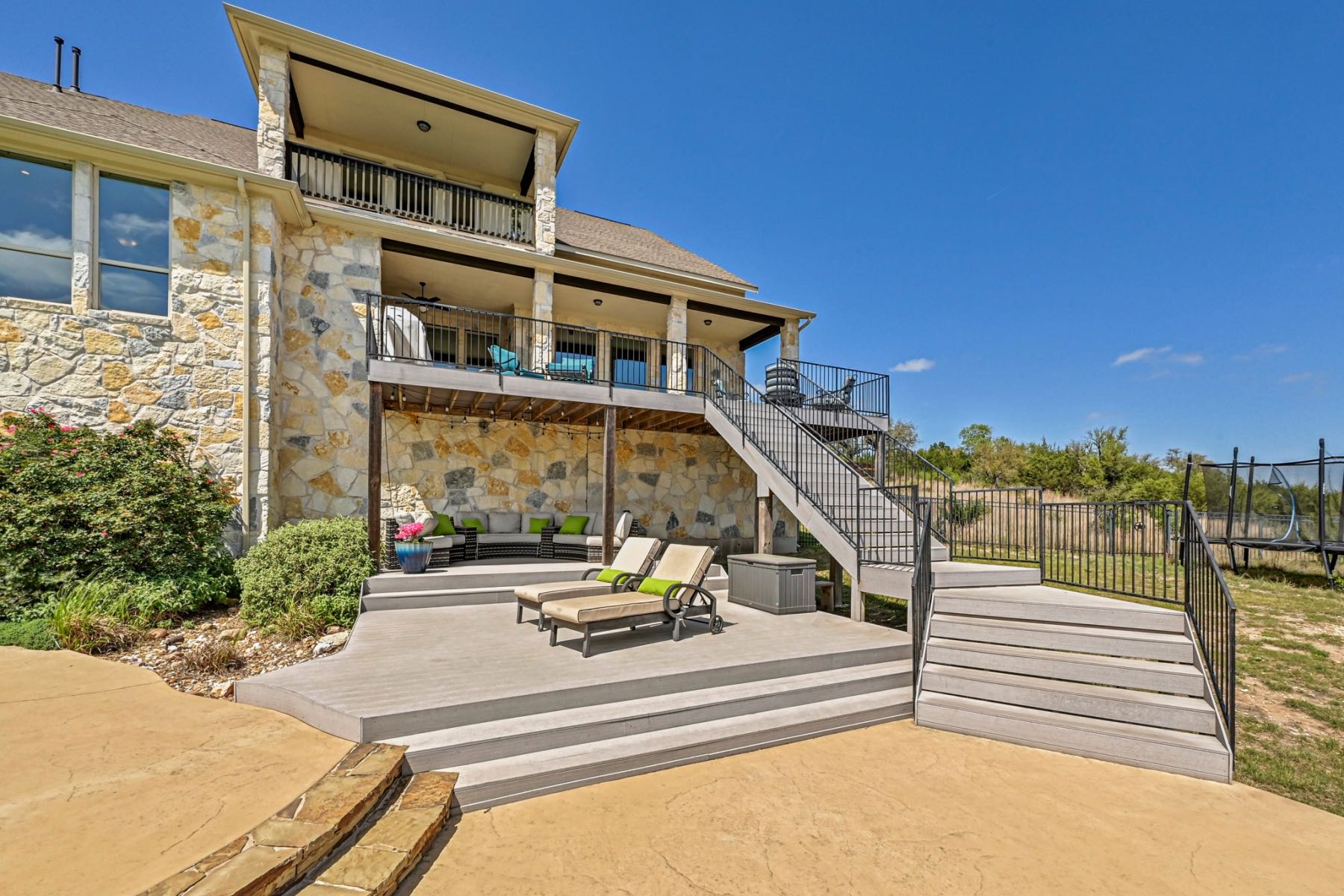 Back exterior of 171 Ferdinand Ct Austin TX 78737 showing tiered decks and patios