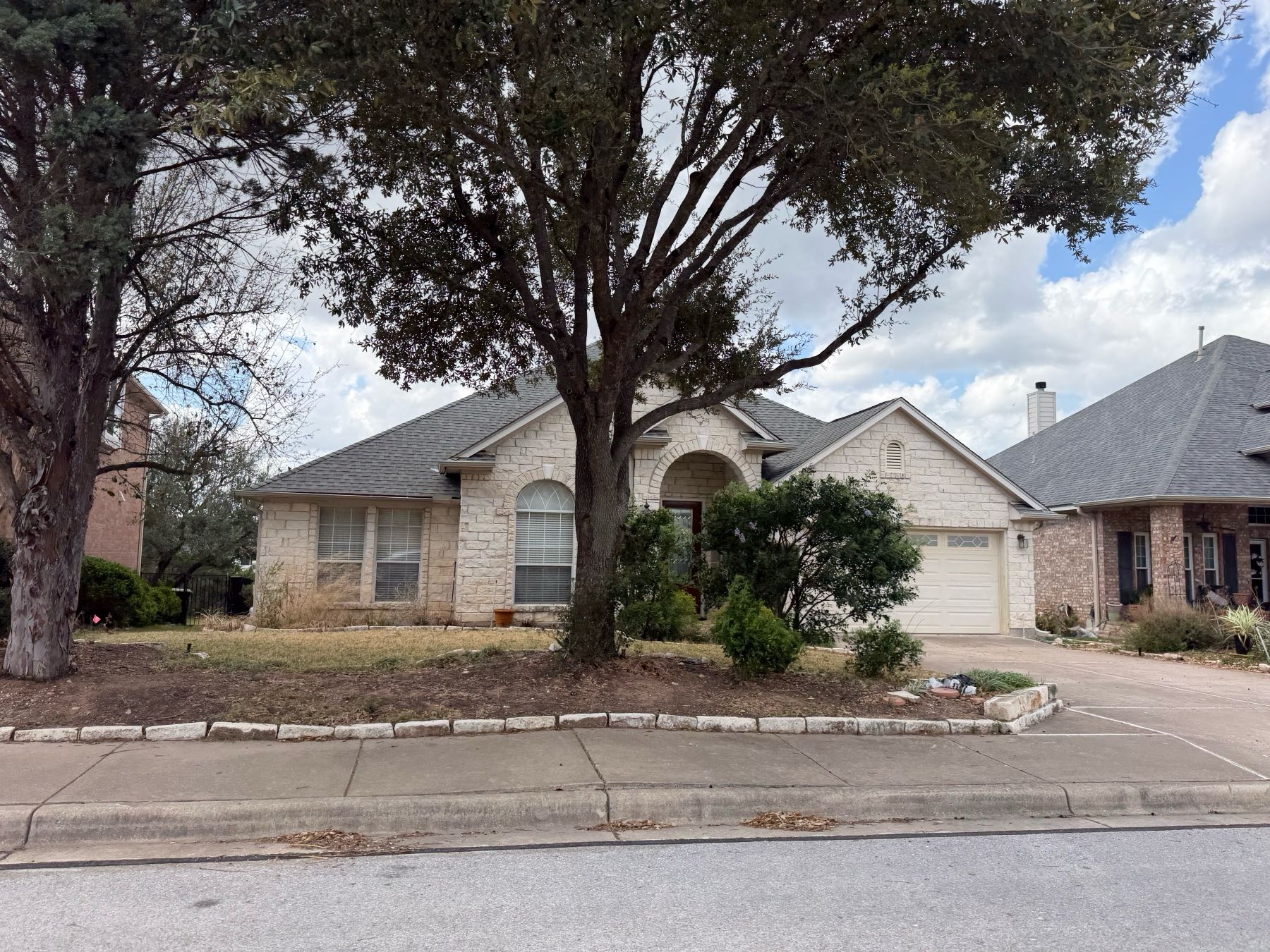 One-story stone home in Lake Pointe Austin TX 78738 — family neighborhood near Lake Travis with top-rated schools