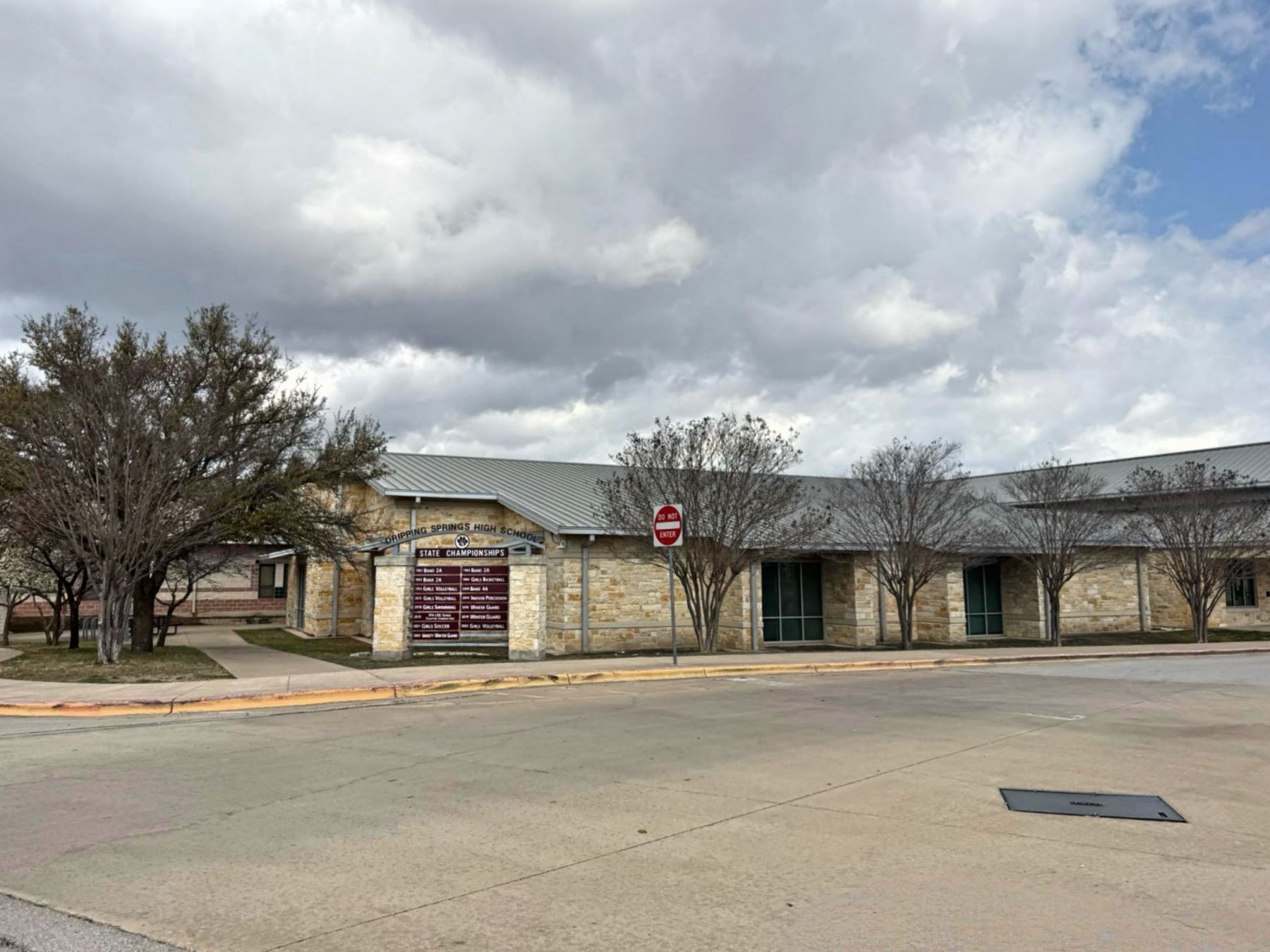 Dripping Springs High School building and marquee sign in Dripping Springs Texas 78620
