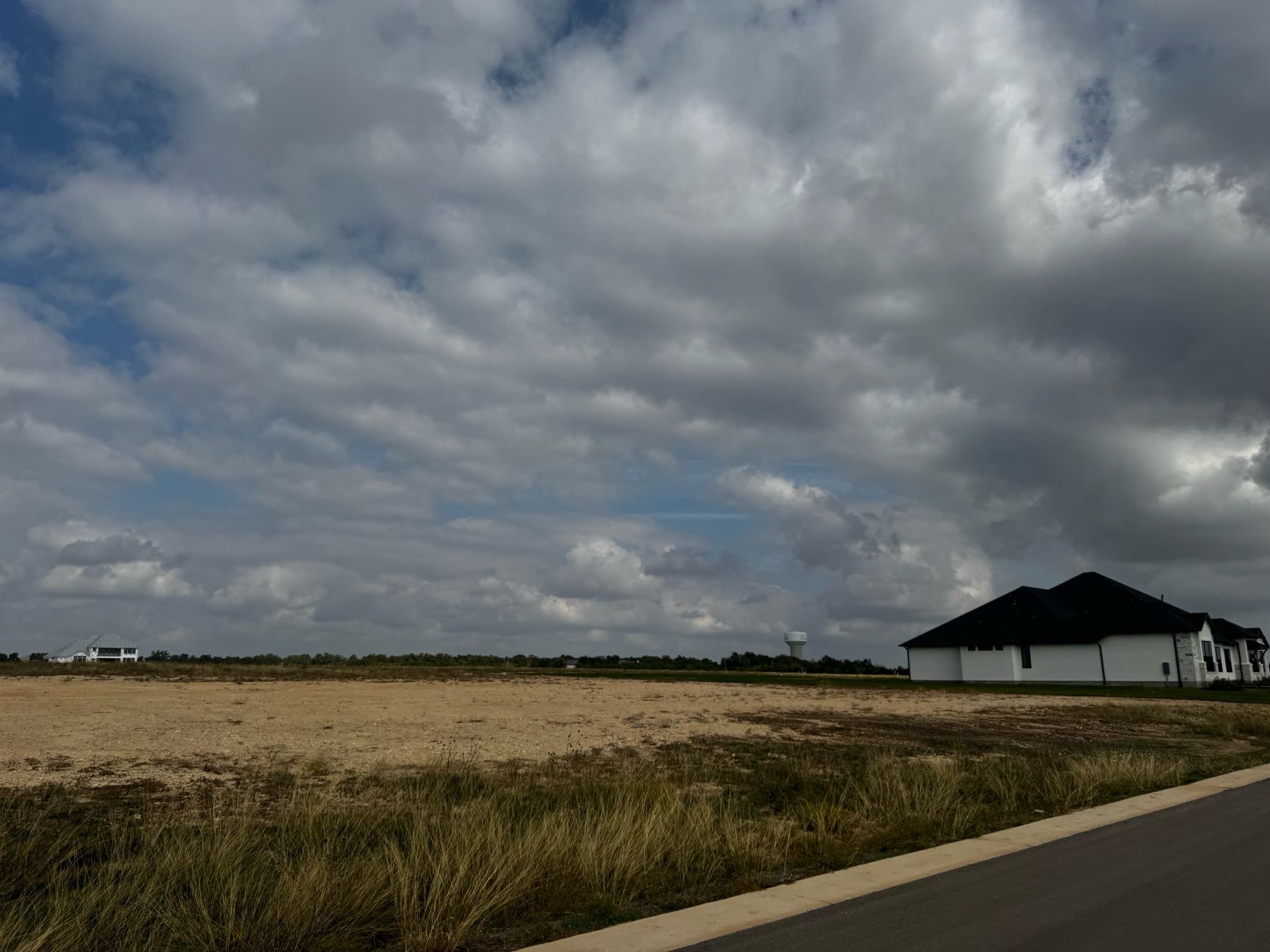 New construction home being built in Hilltop Ranch Leander TX 78641 with water tower visible in background