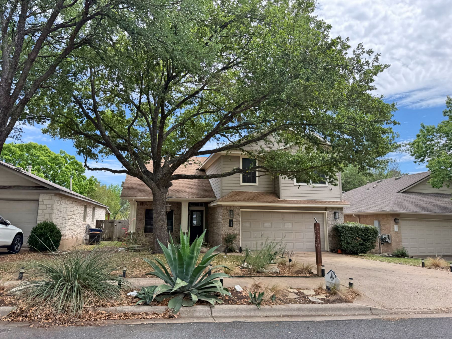 Two story home with agave and xeriscape front yard landscaping in Southland Oaks Austin TX 78748
