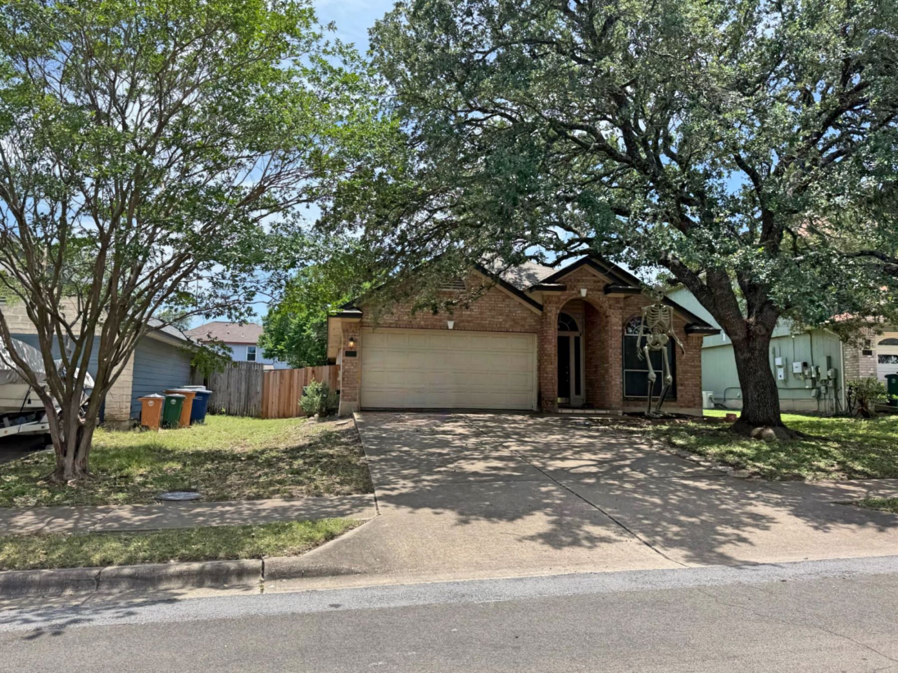 Single-story brick home in Parkwood Austin TX 78748 with a shaded front yard and mature trees