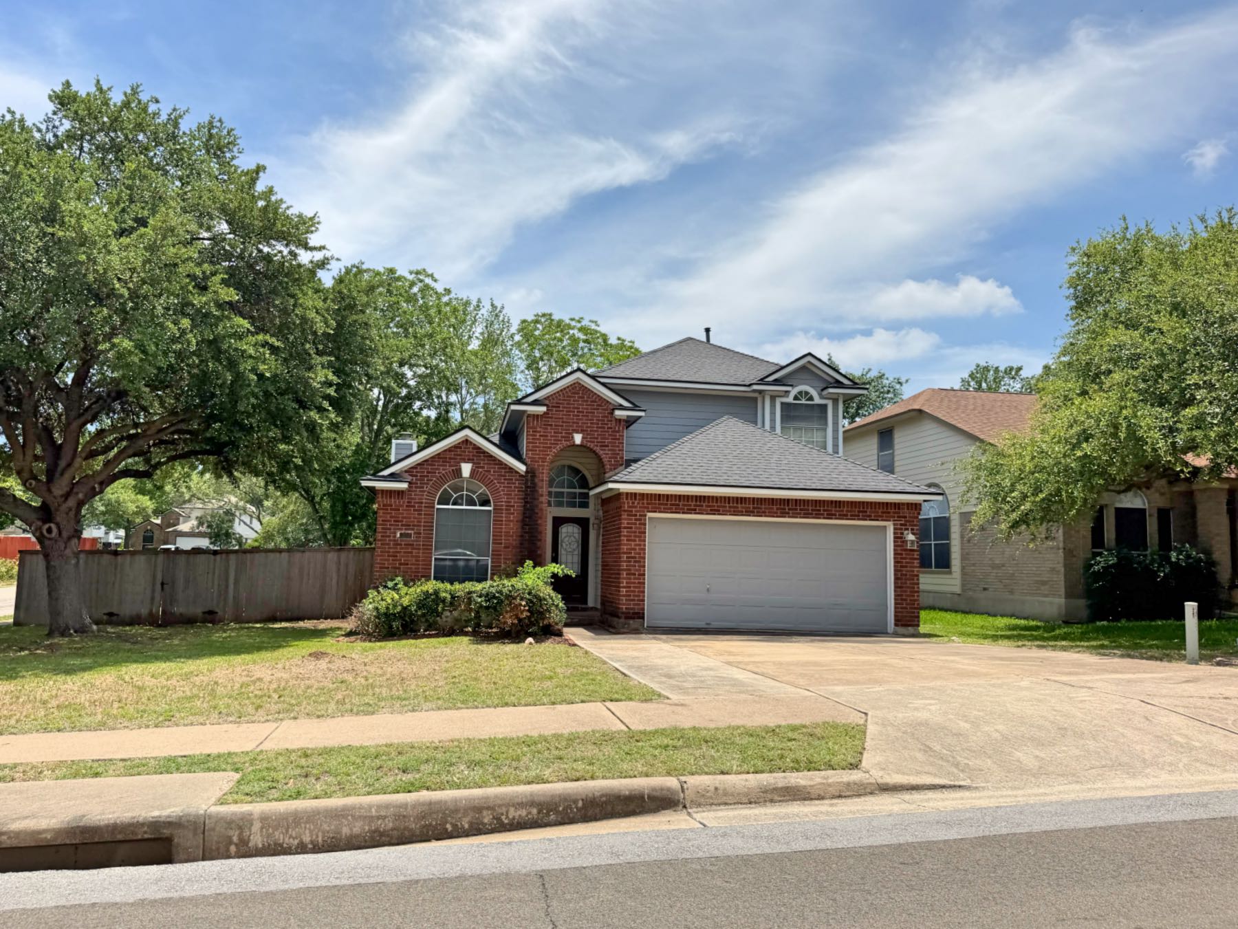 Spacious two-story brick home in Parkwood Austin TX 78748 with a large open front yard