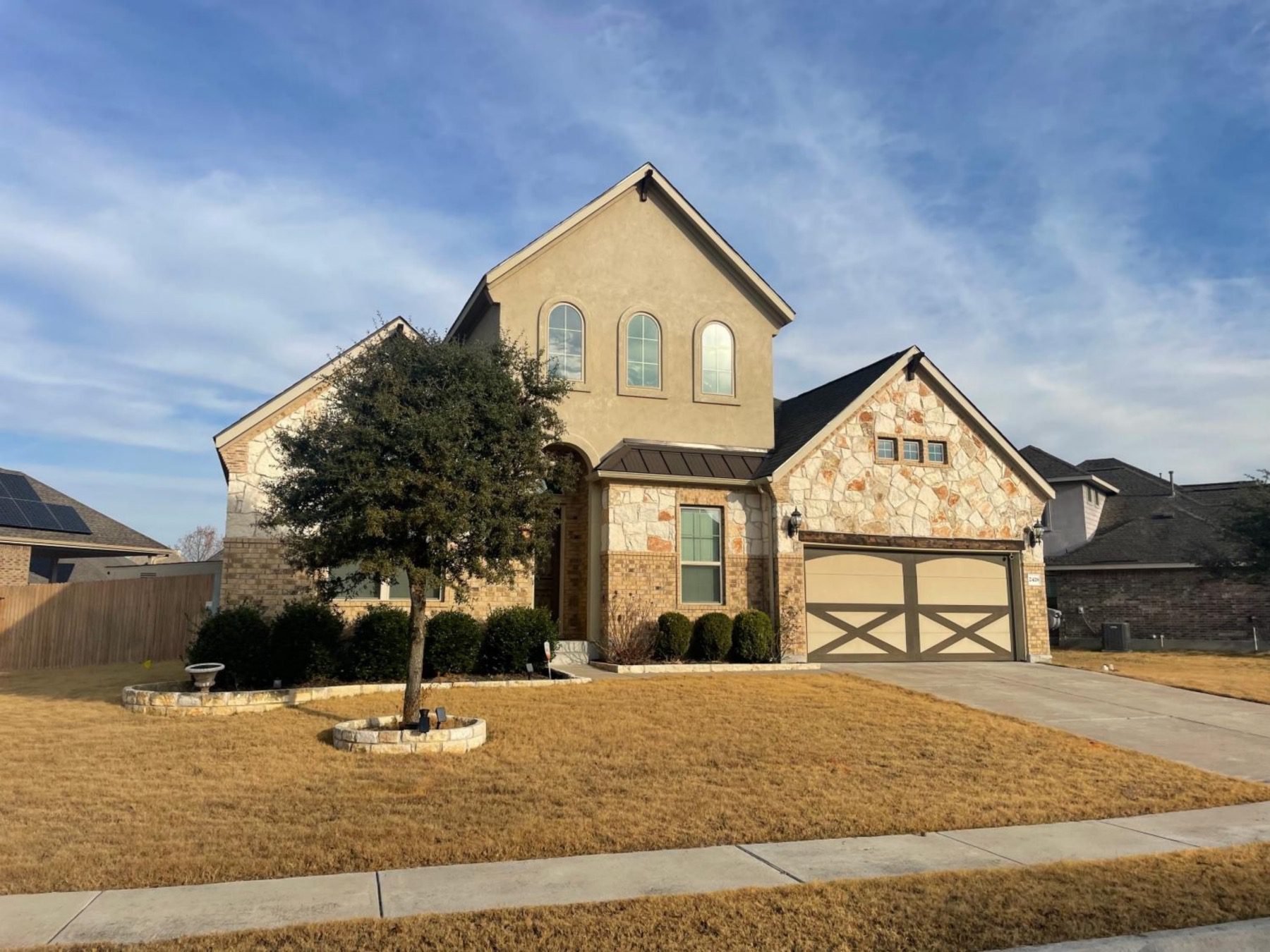 pecan creek stone brick stucco home in leander texas