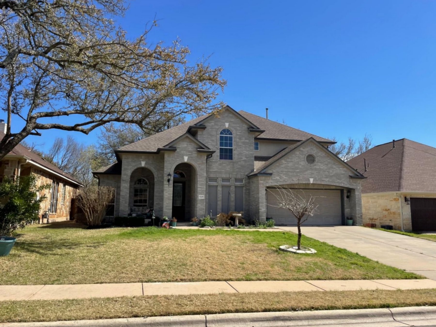 travis country west grey brick home in Austin texas 78735