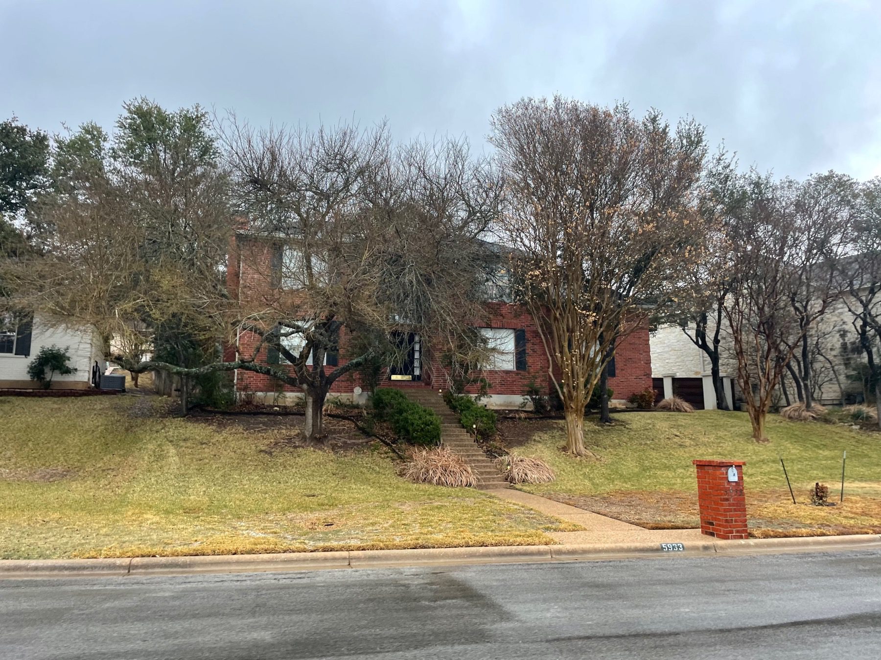 hills of lost creek brick home with shutters Austin