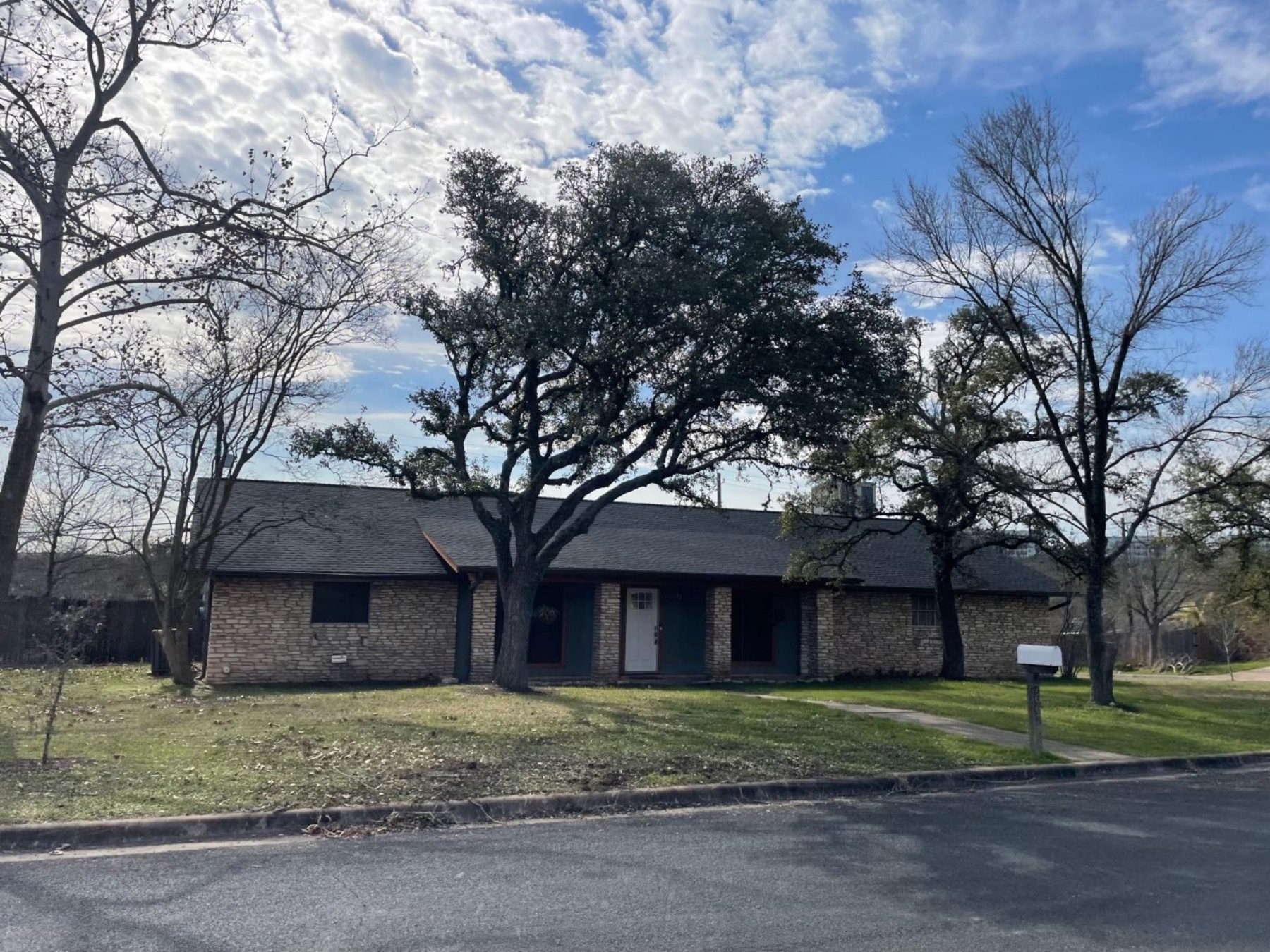 scenic brook west one story home with mature trees Austin 78736