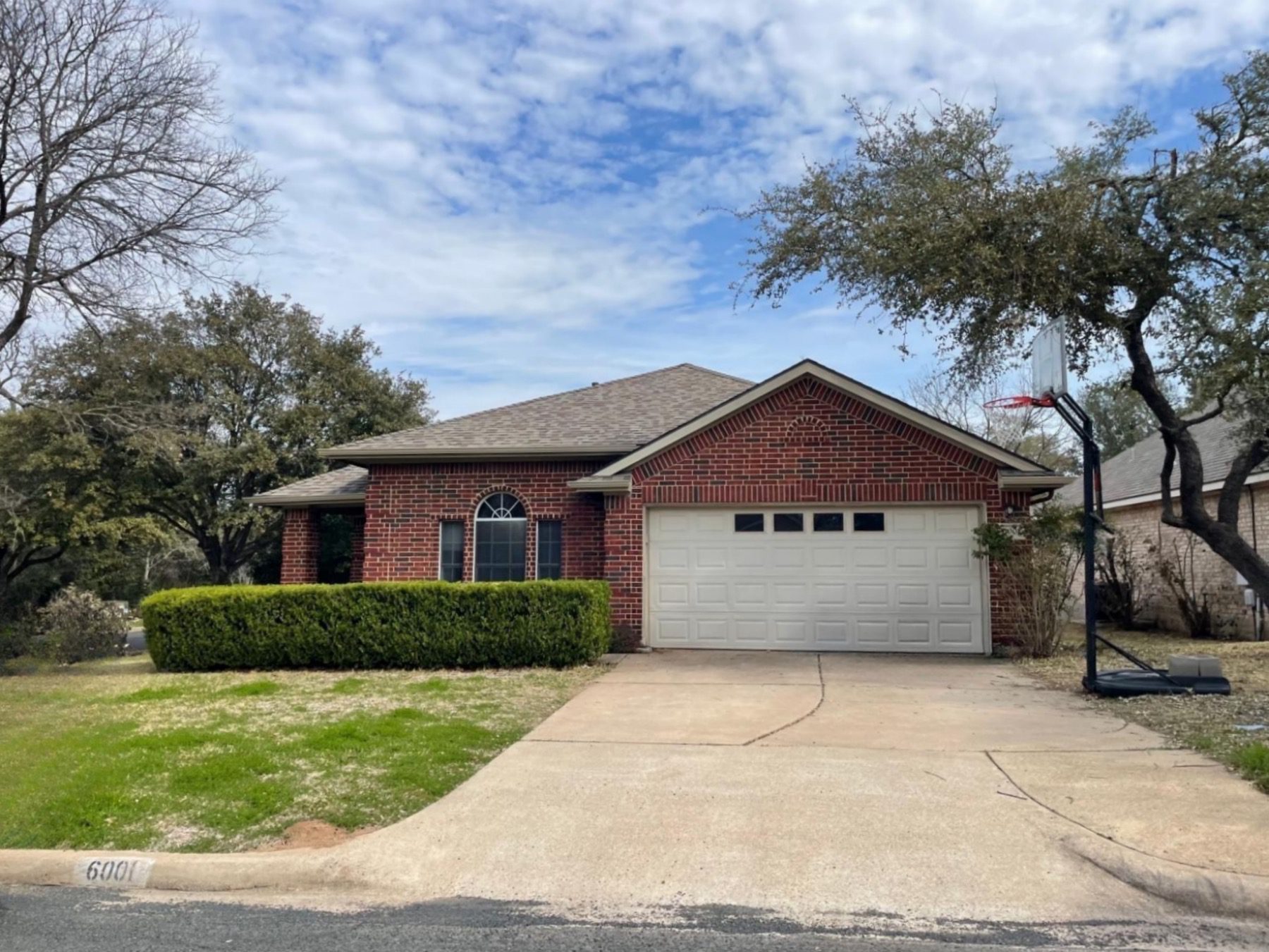village at western oaks one story red brick home Austin 78749